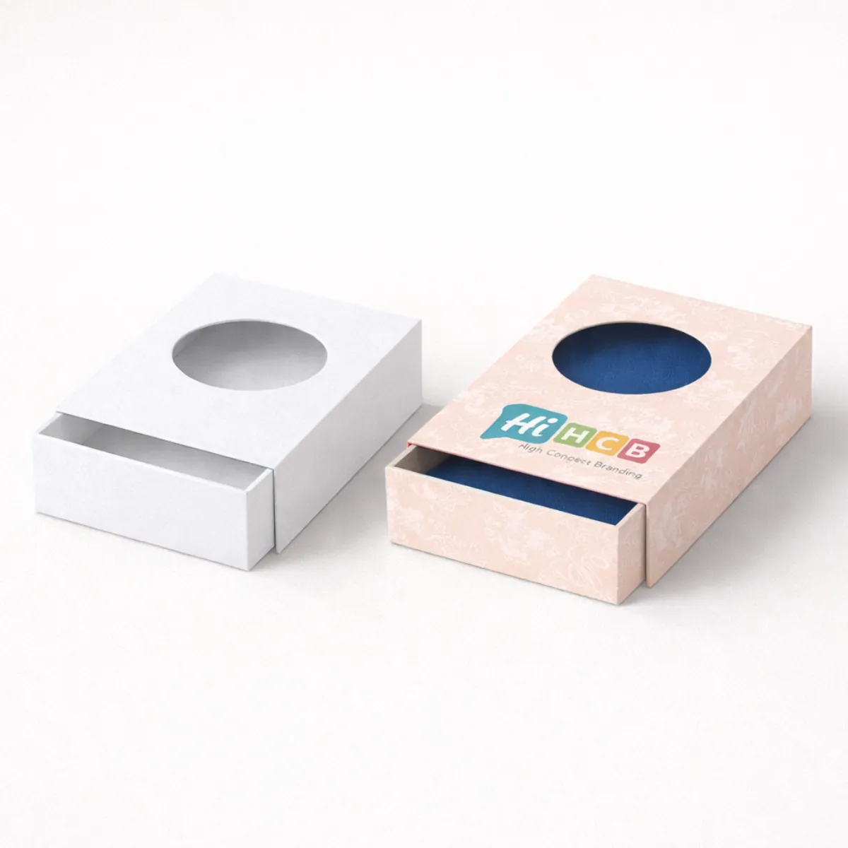 Two sliding drawer boxes with circular window cut-outs- one plain white and one patterned pink- class=